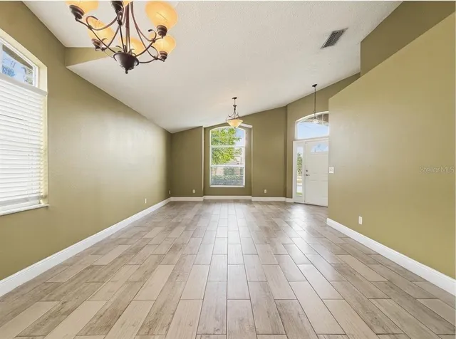 a kitchen with granite countertop a sink a stove top oven a counter space and cabinets