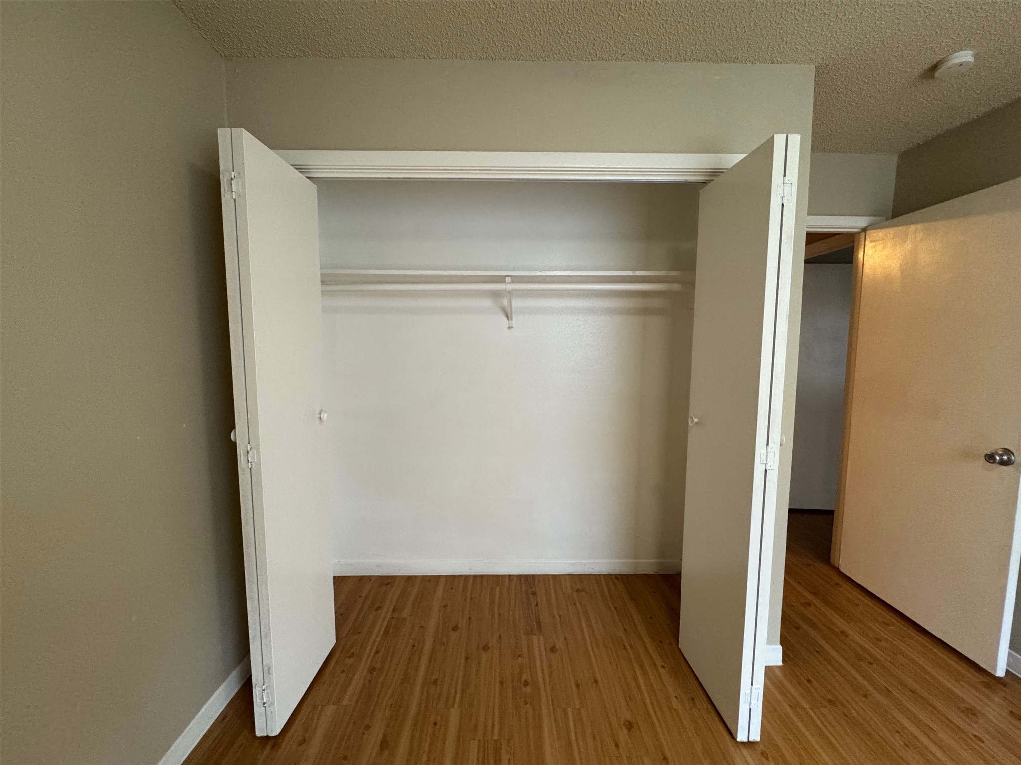 4902 West Wind Trail, Unit 103 Austin, TX 78745 - Photo 11 of 20 a view of walk in closet with wooden floor