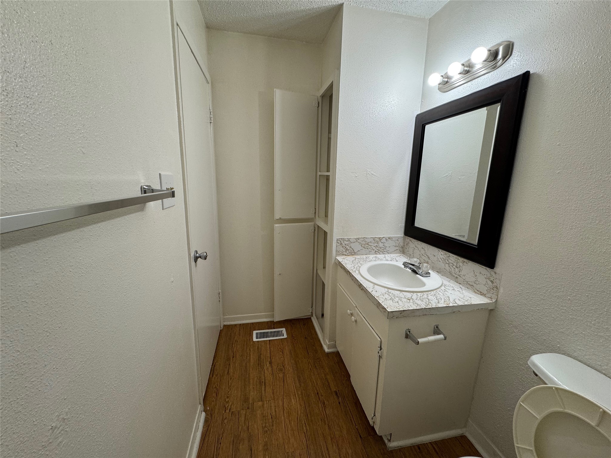 4902 West Wind Trail, Unit 103 Austin, TX 78745 - Photo 13 of 20 a bathroom with a toilet sink and mirror