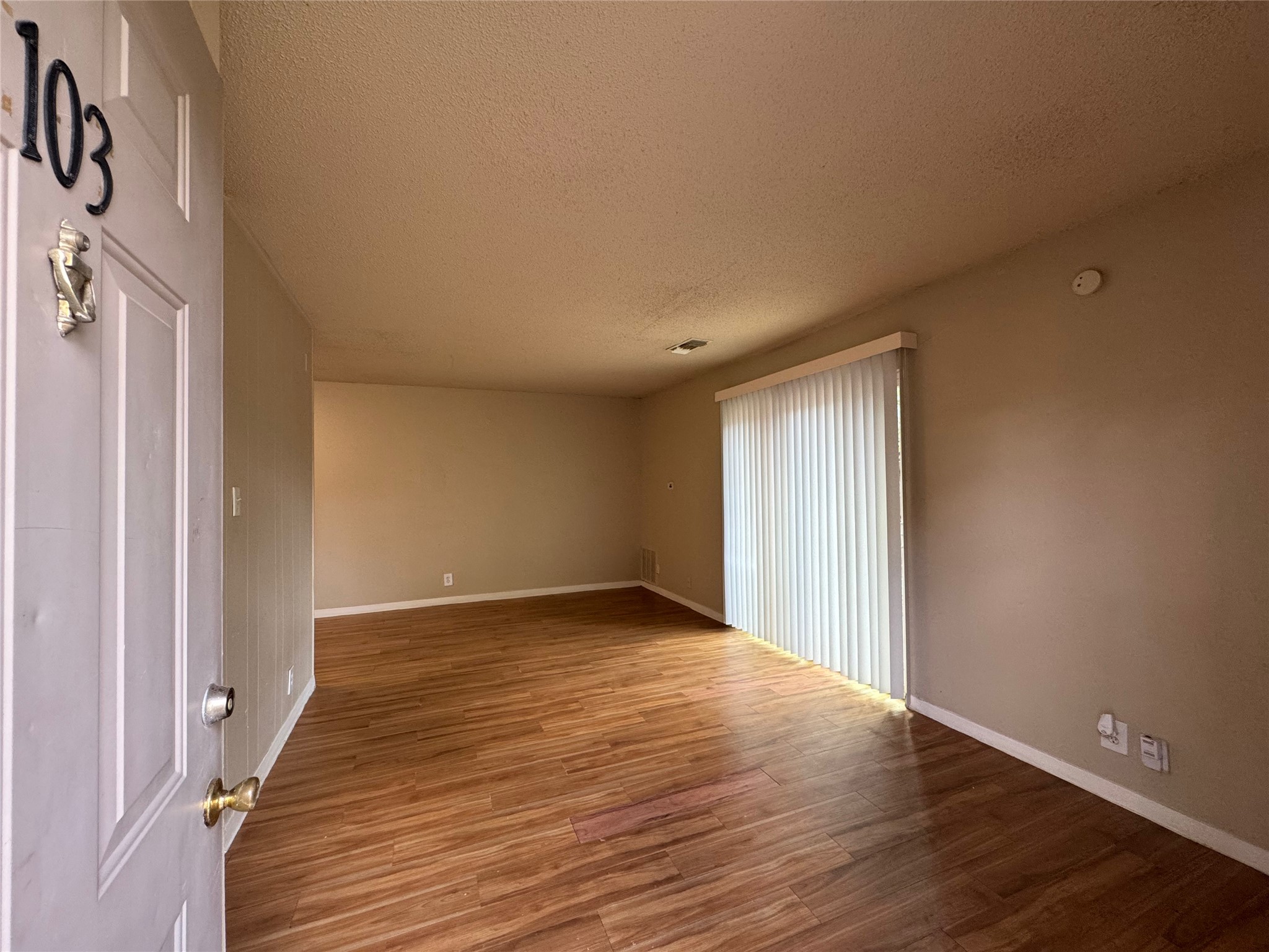 4902 West Wind Trail, Unit 103 Austin, TX 78745 - Photo 2 of 20 a view of an empty room with wooden floor