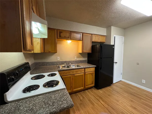 a kitchen with a refrigerator and a stove