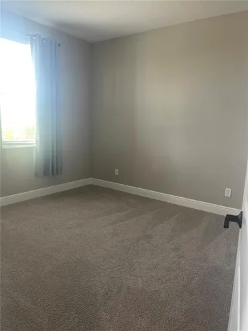 an empty room with closet and a bathroom