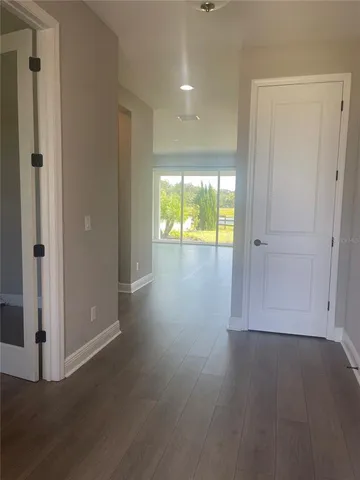 an empty room with wooden floor and a window