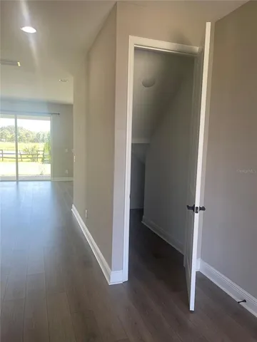 an empty room with wooden floor and a window