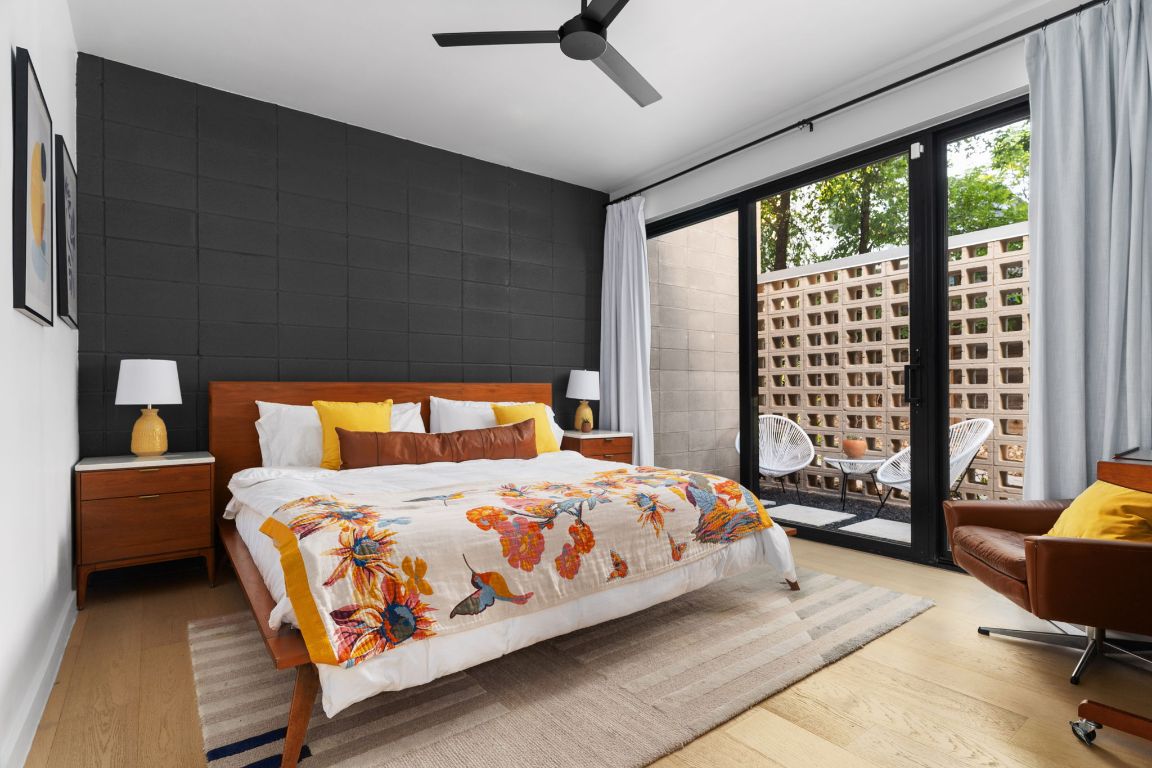 1206 Luna Street Austin, TX 78721 - Photo 11 of 27 a bedroom with a bed and large windows