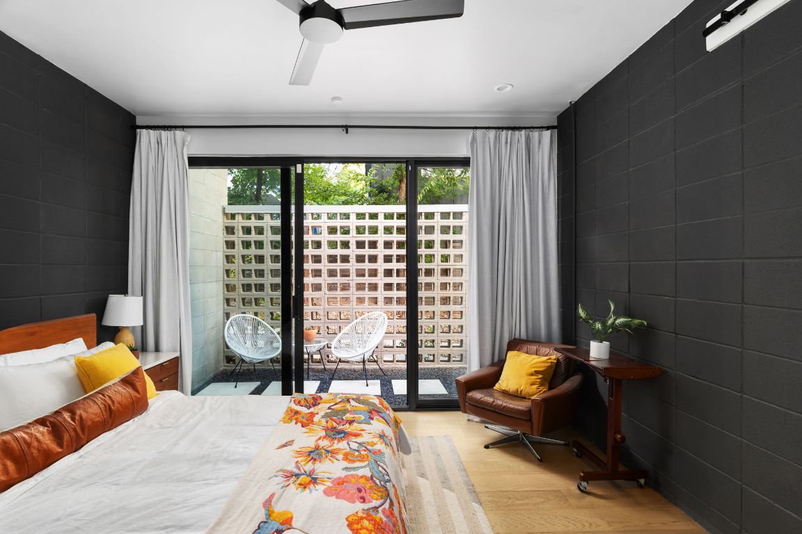 1206 Luna Street Austin, TX 78721 - Photo 15 of 27 a bedroom with a bed and wooden floor