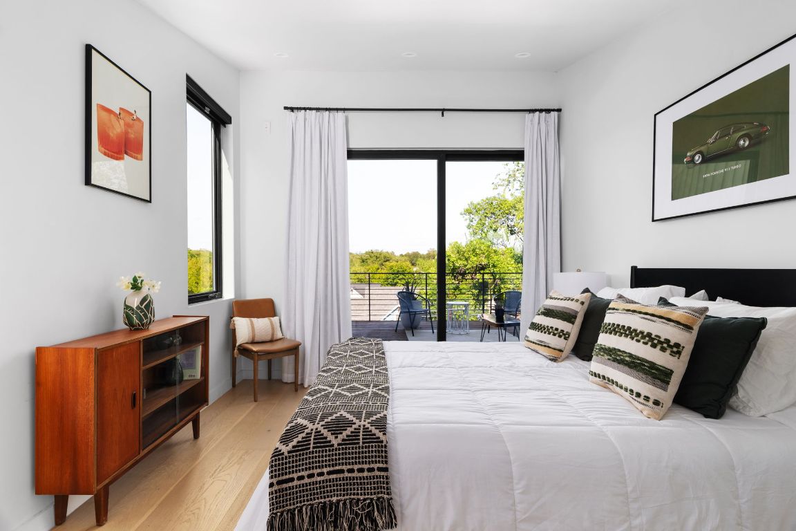 1206 Luna Street Austin, TX 78721 - Photo 17 of 27 a bedroom with furniture and large windows