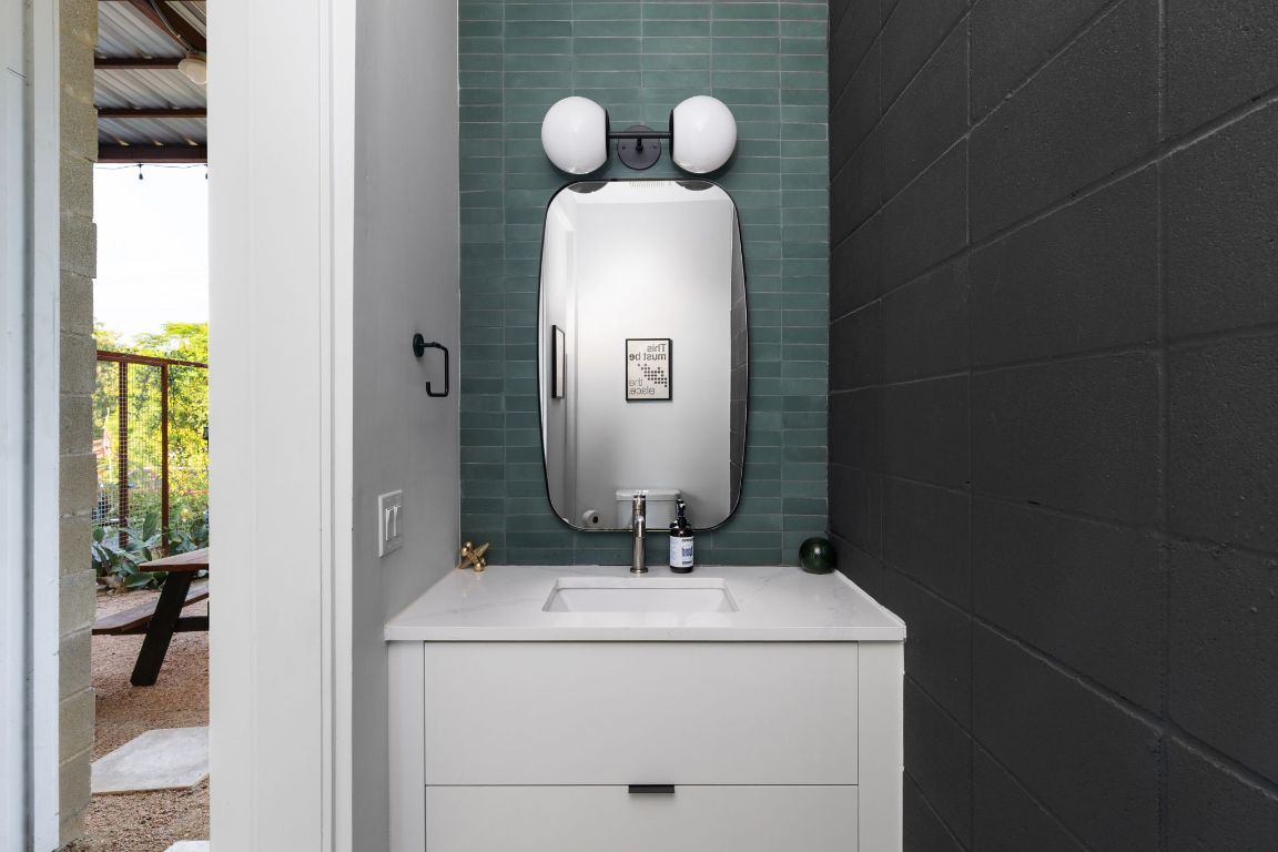 1206 Luna Street Austin, TX 78721 - Photo 23 of 27 a bathroom with a sink and a mirror