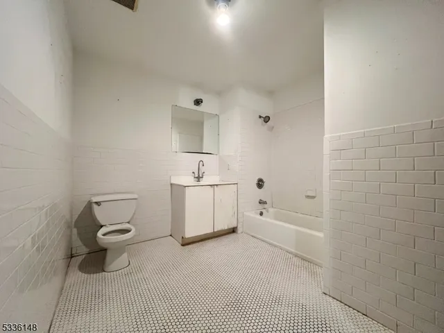 a bathroom with a sink a toilet and bathtub