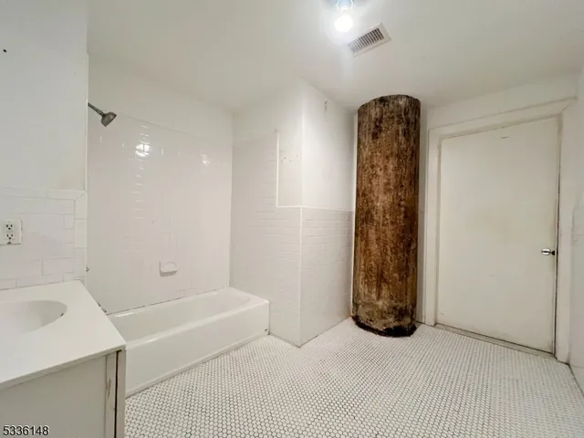 a bathroom with a bathtub and shower