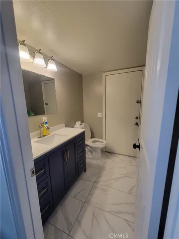 a bathroom with a sink vanity and mirror