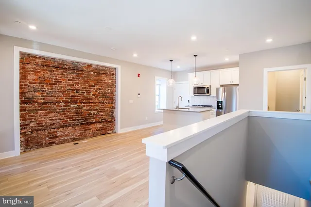 a kitchen with granite countertop a stove and cabinets