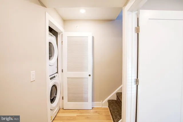 a view of a hallway with washer and dryer