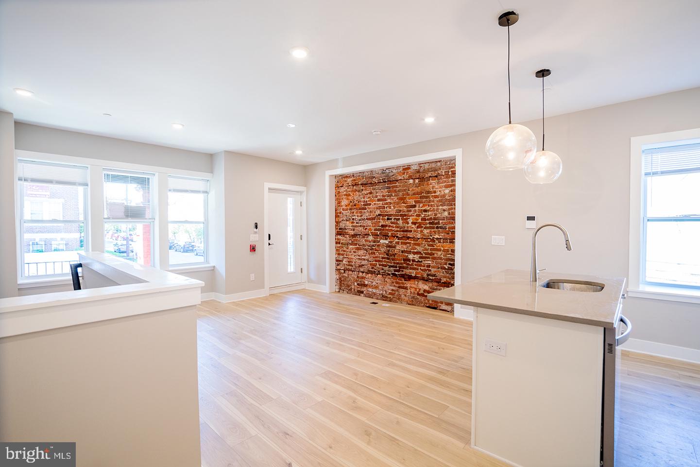 129 South 49th Street, Unit 1F Philadelphia, PA 19139 - Photo 6 of 18 a view of an empty room with a window and wooden floor