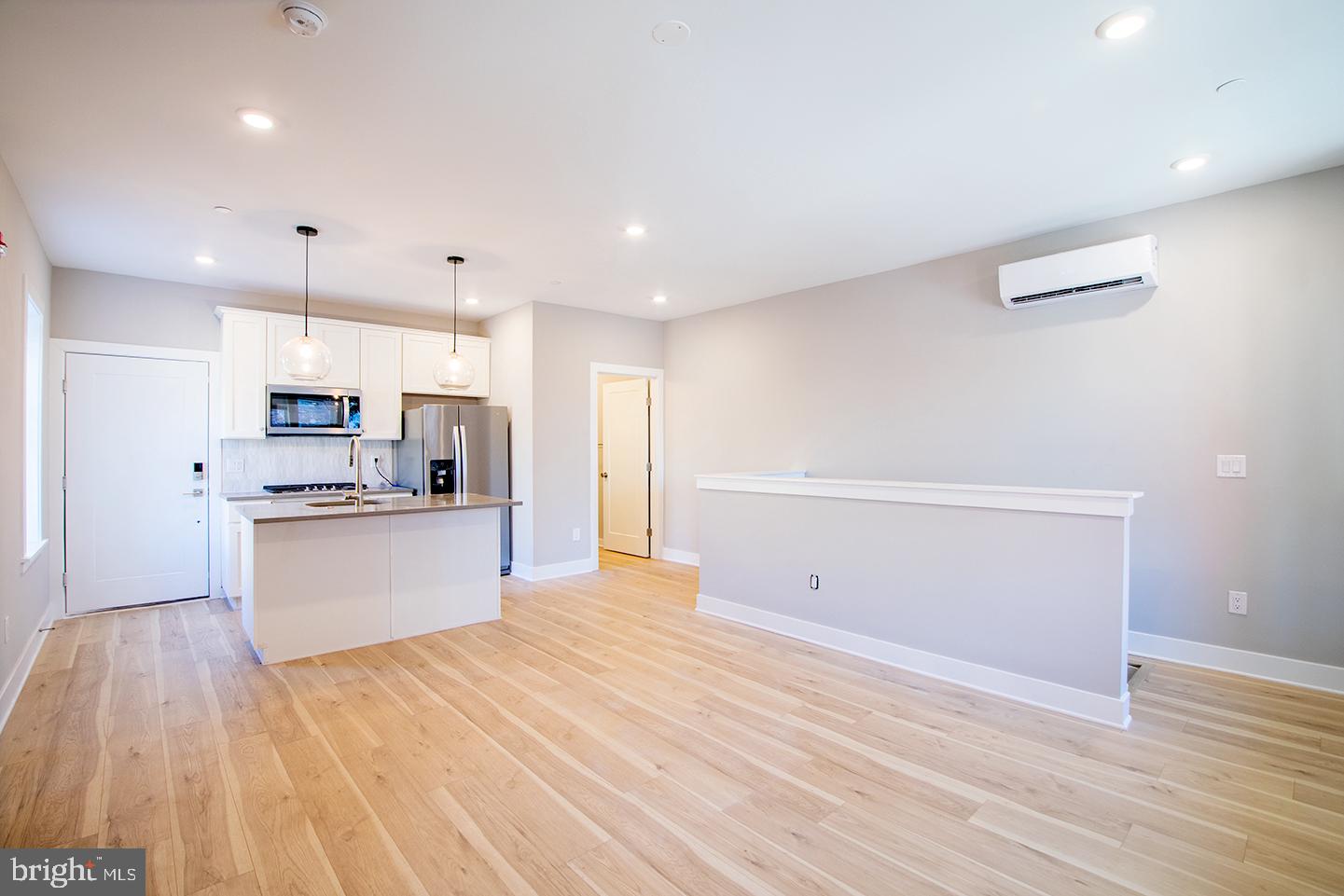 129 South 49th Street, Unit 1F Philadelphia, PA 19139 - Photo 7 of 18 a view of kitchen with wooden floor and electronic appliances