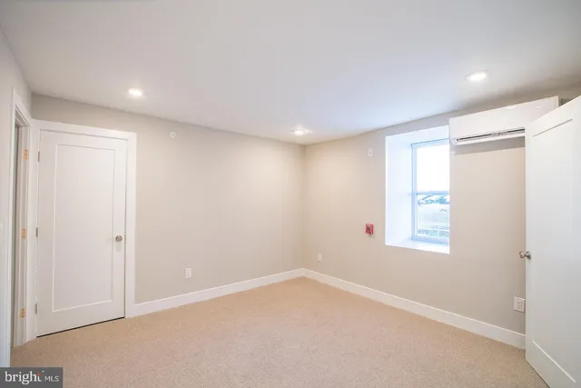 an empty room with windows and closet