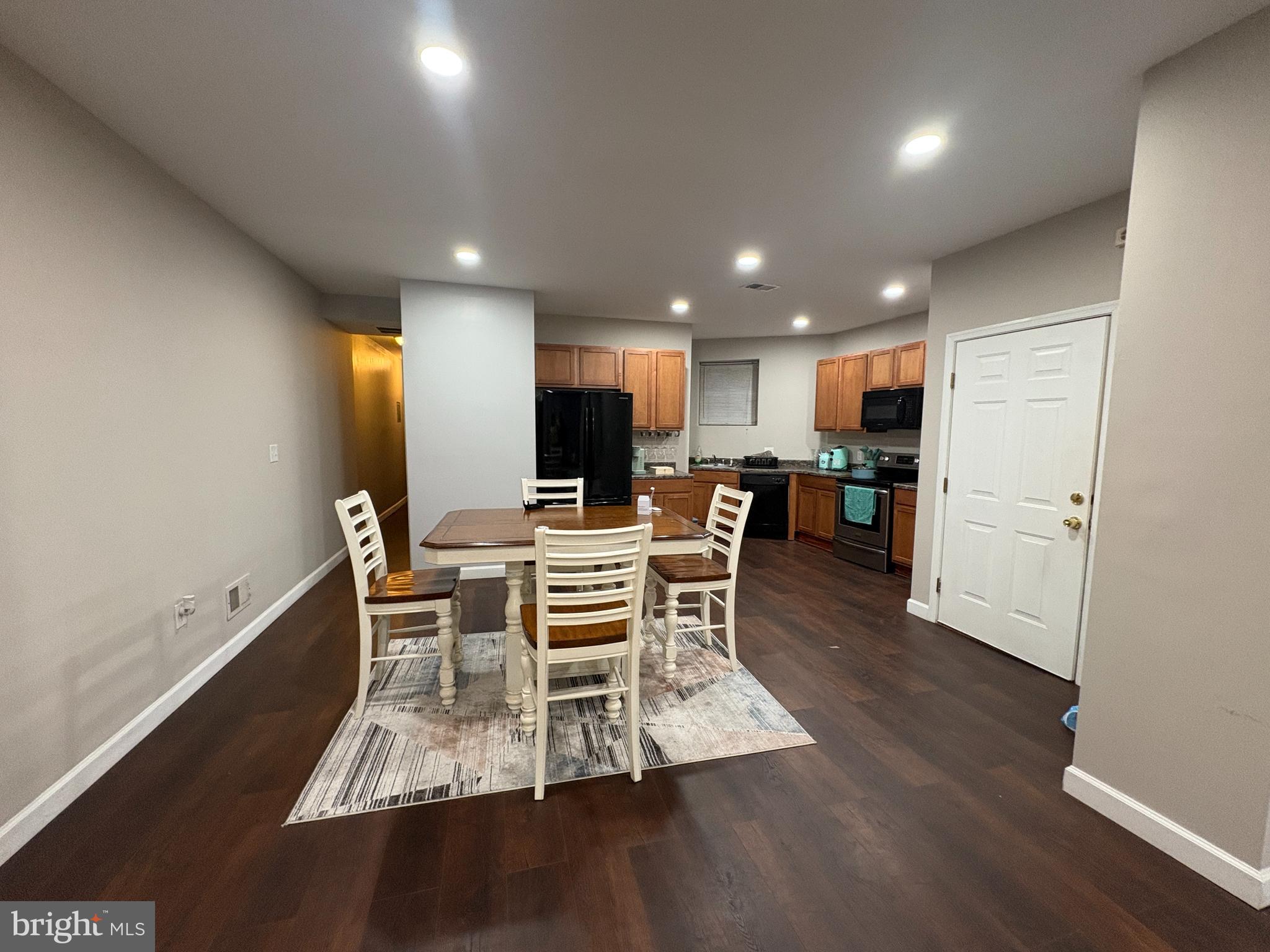 222 North Liberty Street, Unit 2 Baltimore, MD 21201 - Photo 2 of 15 a view of a dining room with furniture a rug and wooden floor