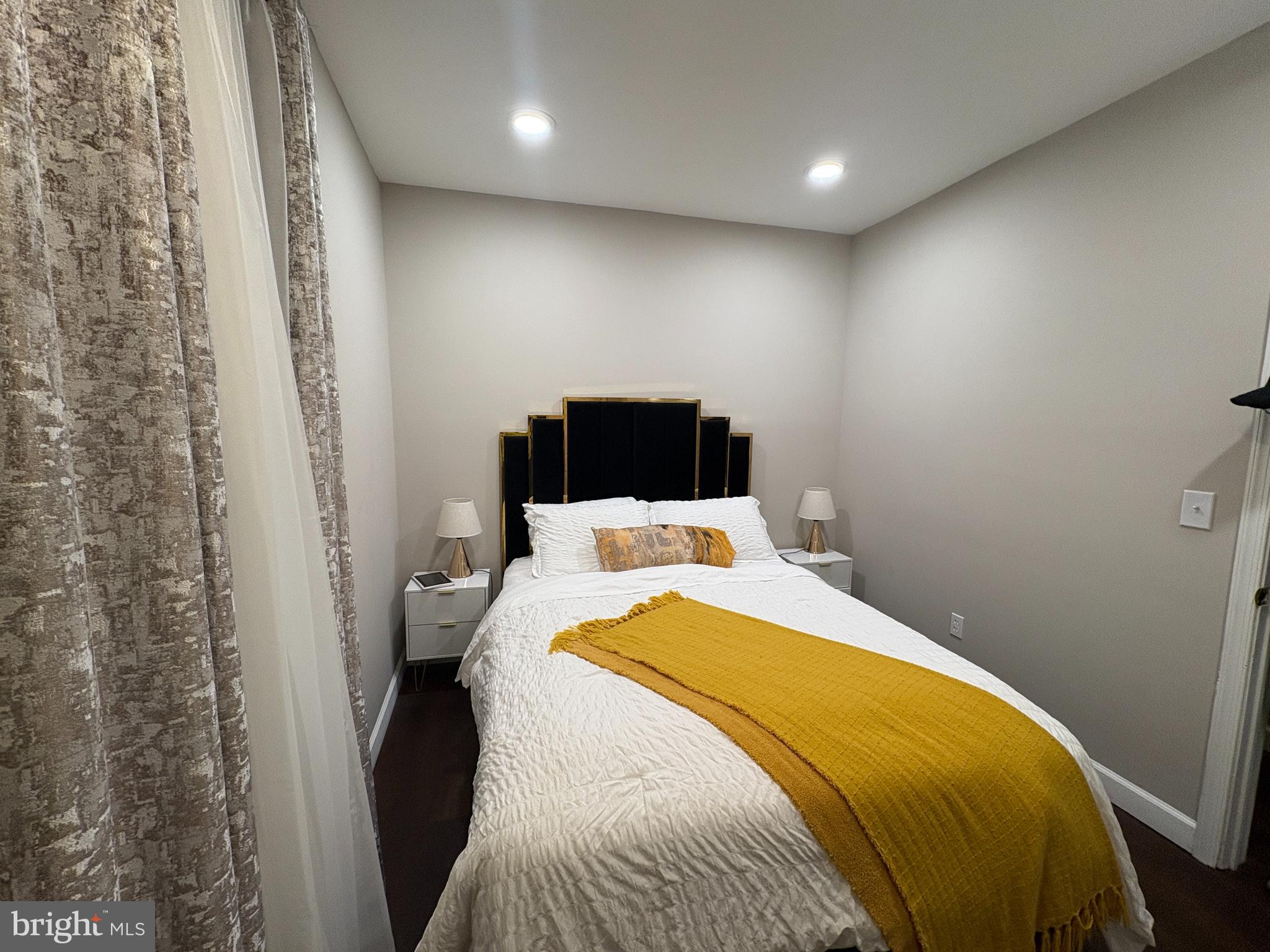 222 North Liberty Street, Unit 2 Baltimore, MD 21201 - Photo 6 of 15 a bedroom with a bed and a wall