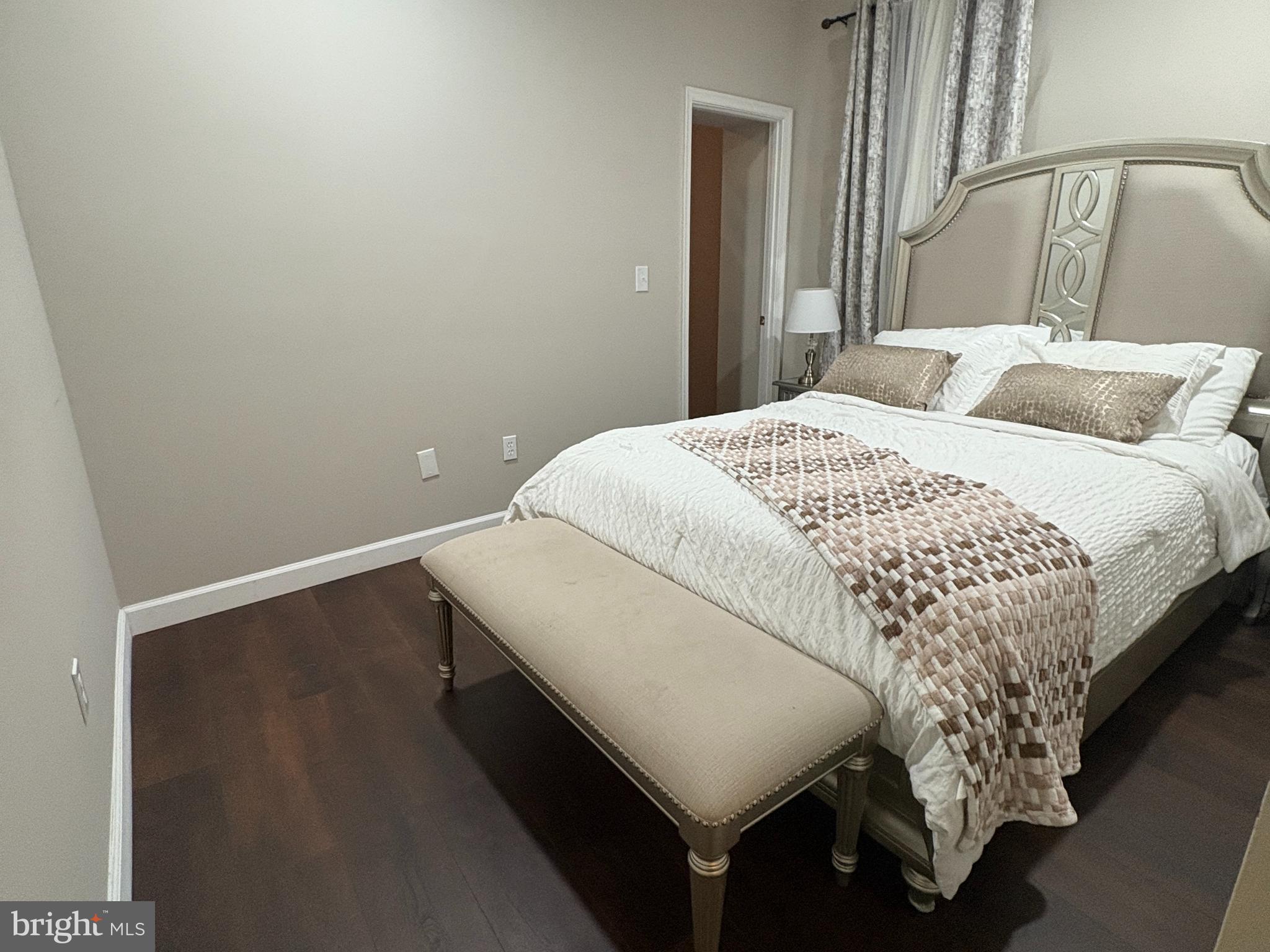 222 North Liberty Street, Unit 2 Baltimore, MD 21201 - Photo 9 of 15 a bedroom with a bed and a night stand