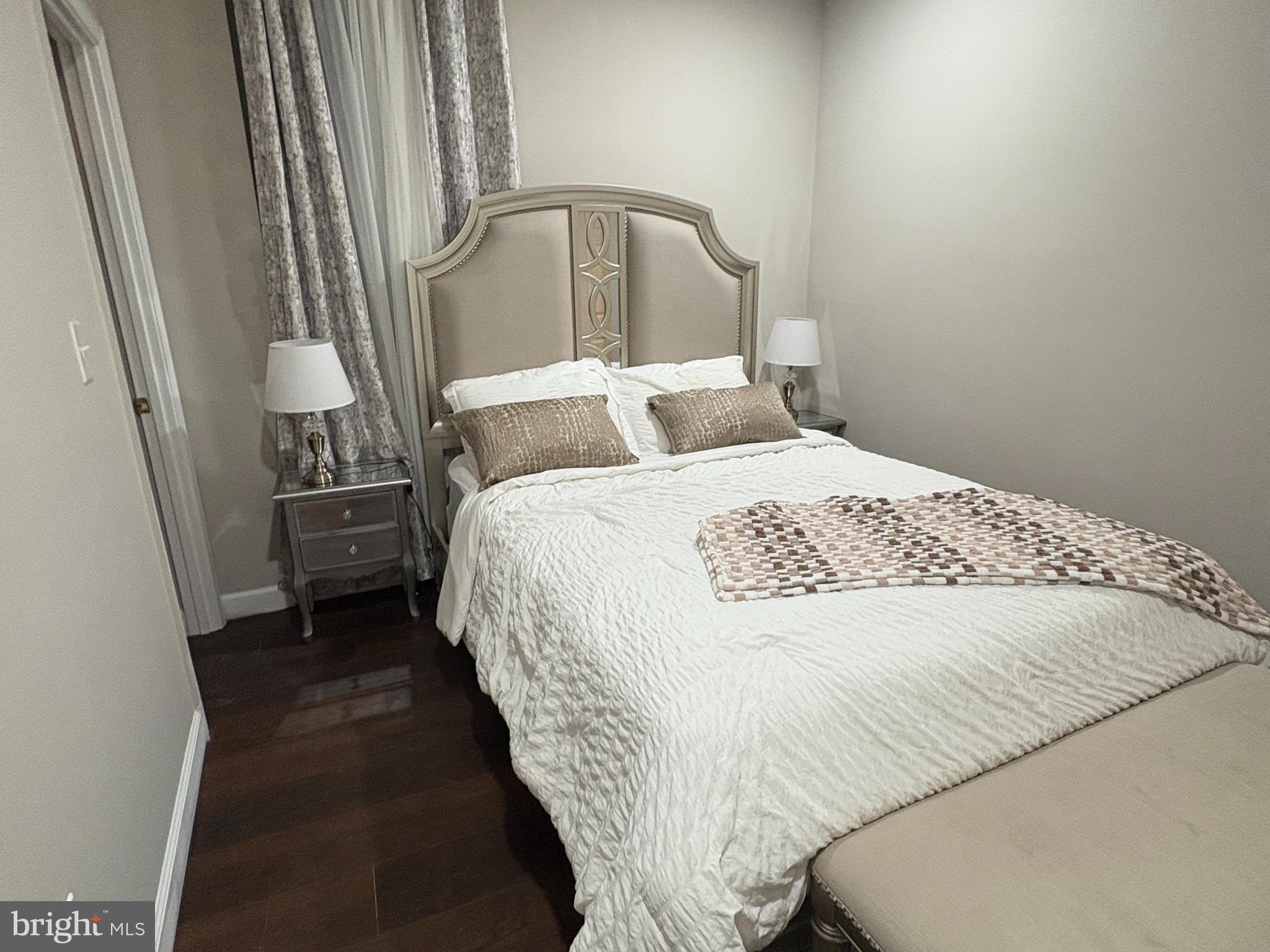 222 North Liberty Street, Unit 2 Baltimore, MD 21201 - Photo 10 of 15 a bedroom with a bed and a mirror