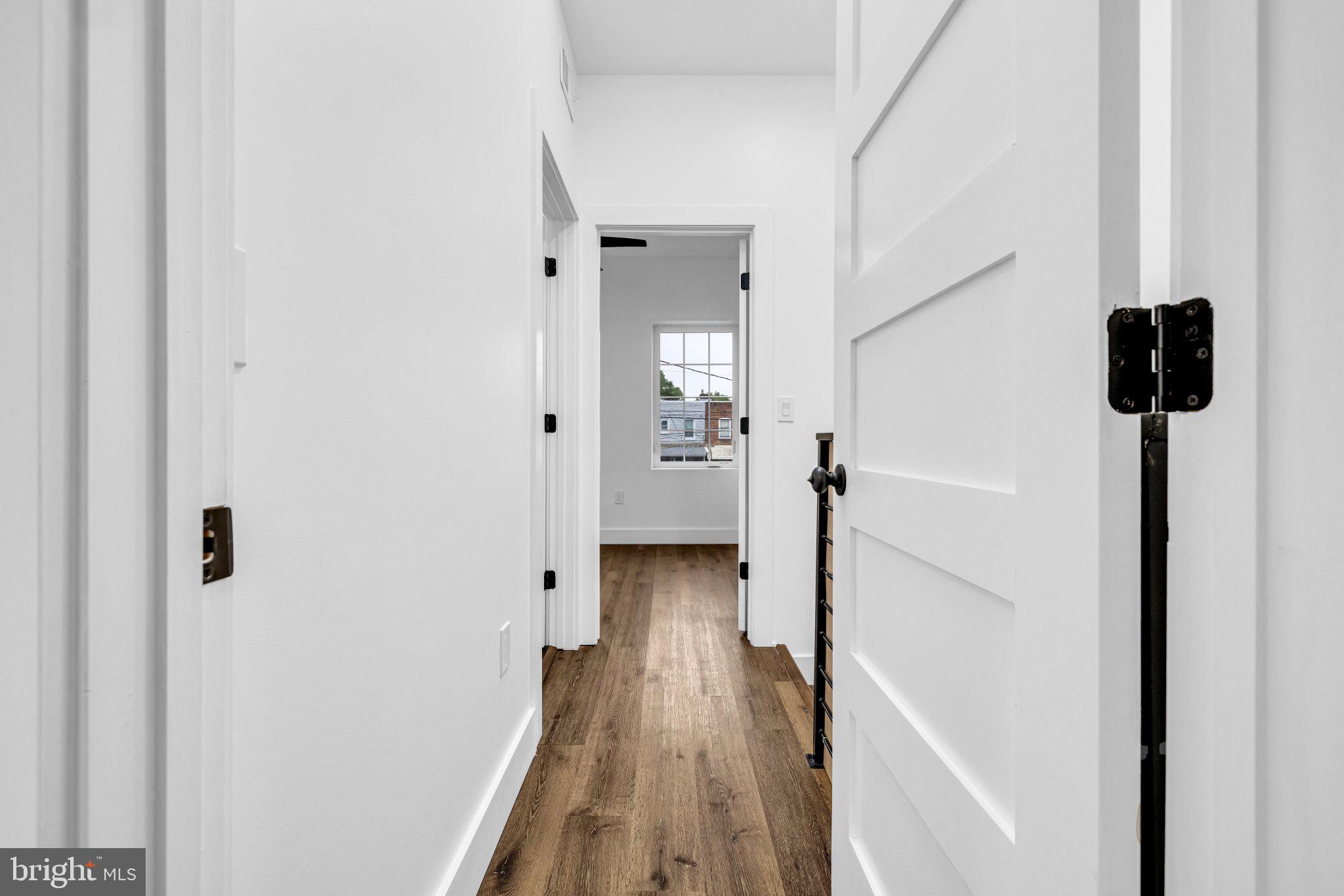 2801 Round Road Baltimore, MD 21225 - Photo 15 of 29 a view of a hallway with wooden floor and staircase