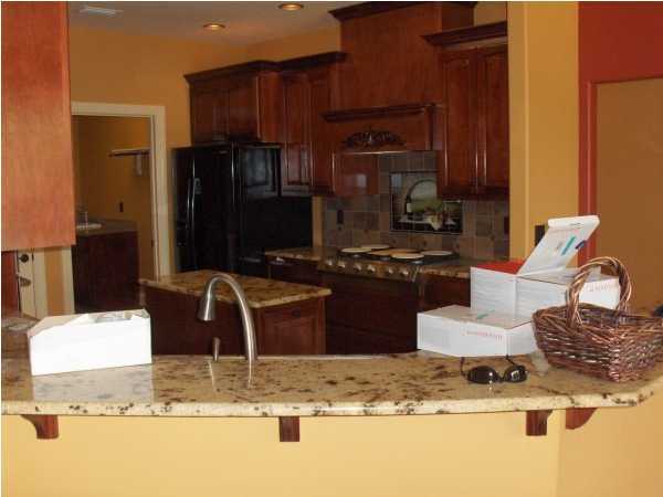 196 West Burnis Road Crestview, FL 32539 - Photo 11 of 13 a kitchen with a refrigerator and a stove