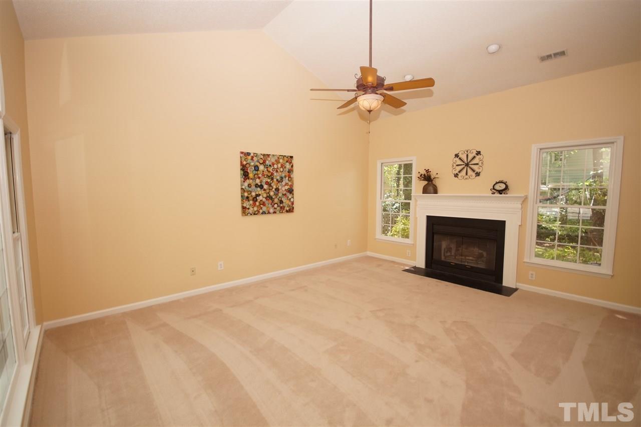 5208 Blakeley Lane Raleigh, NC 27613 - Photo 4 of 25 a view of a livingroom with a fireplace and a ceiling fan