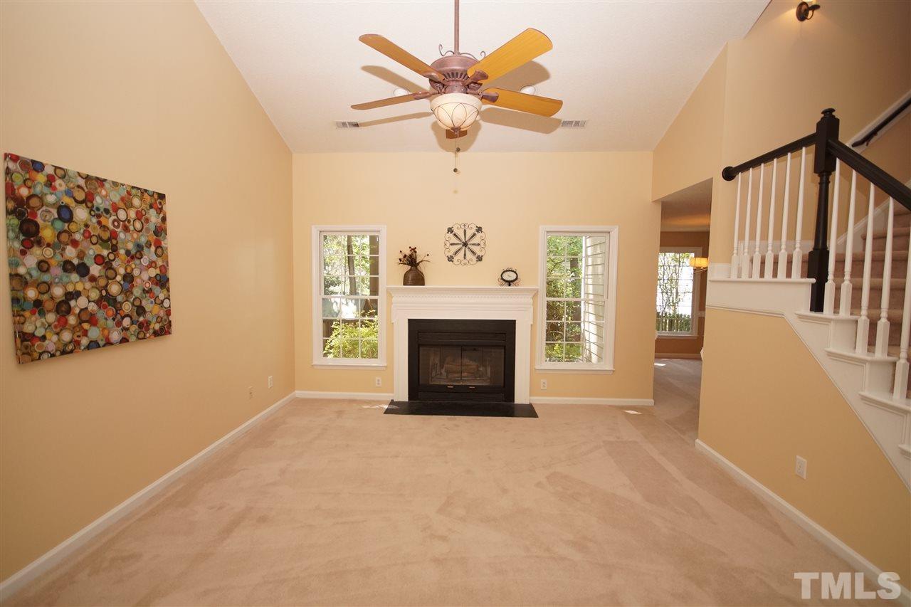 5208 Blakeley Lane Raleigh, NC 27613 - Photo 5 of 25 a view of a livingroom with a fireplace and a chandelier fan