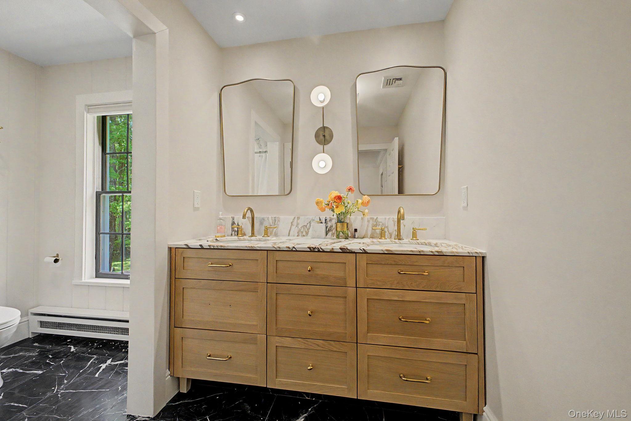 240 Eastwoods Road Pound Ridge, NY 10576 - Photo 35 of 46 a bathroom with a double vanity sink mirror and window