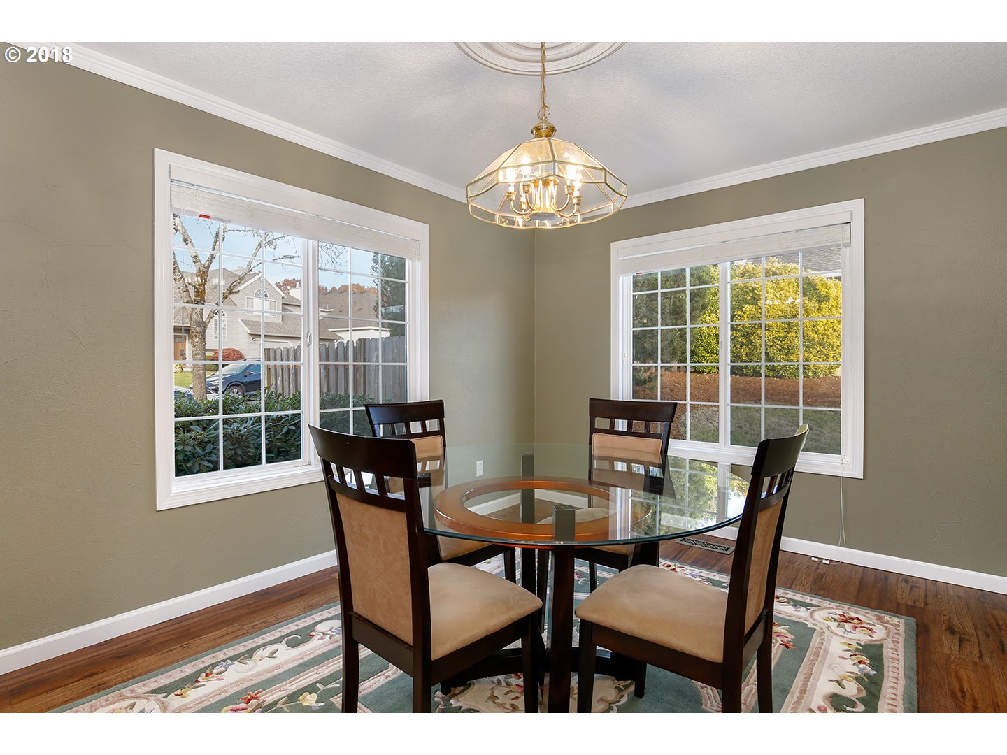 10470 Southwest 135th Avenue Beaverton, OR 97008 - Photo 15 of 32 a view of a dining room with furniture a chandelier and wooden floor
