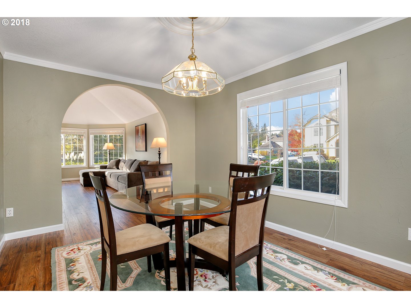 10470 Southwest 135th Avenue Beaverton, OR 97008 - Photo 16 of 32 a view of a dining room with furniture a chandelier and wooden floor