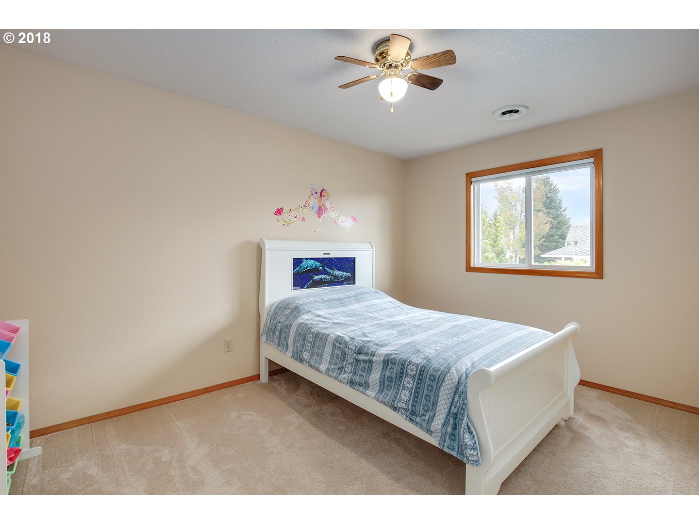 10470 Southwest 135th Avenue Beaverton, OR 97008 - Photo 17 of 32 a bedroom with a bed and a chandelier