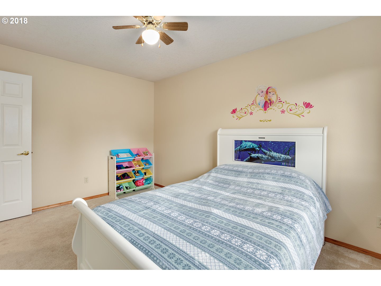 10470 Southwest 135th Avenue Beaverton, OR 97008 - Photo 18 of 32 a bedroom with a bed and a chandelier