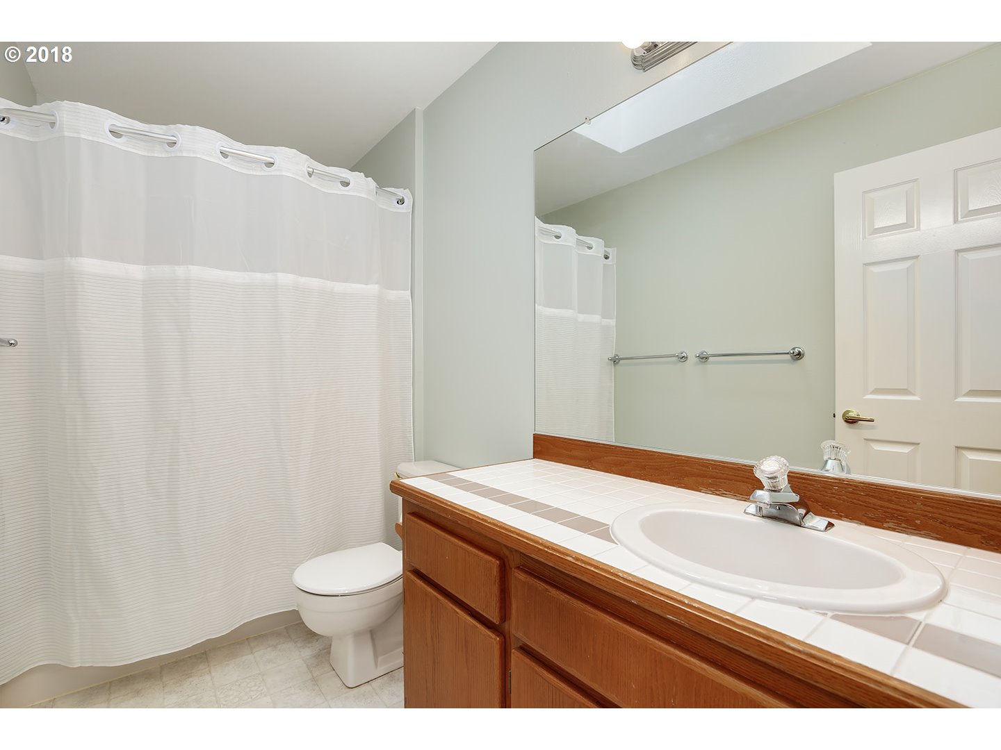 10470 Southwest 135th Avenue Beaverton, OR 97008 - Photo 22 of 32 a bathroom with a sink a toilet and a mirror