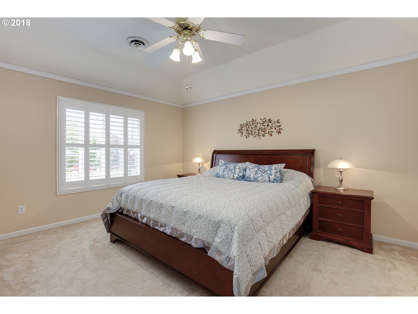 10470 Southwest 135th Avenue Beaverton, OR 97008 - Photo 25 of 32 a spacious bedroom with a bed a chandelier and a window