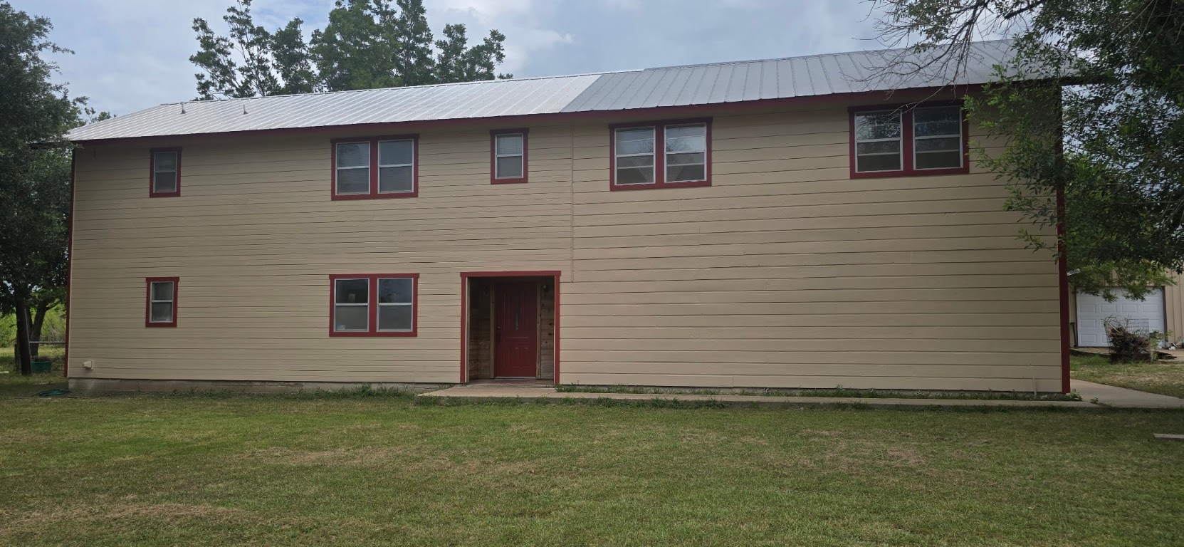 201 930 Par Taylor, TX 76574 - Photo 3 of 27 a front view of a house with a garden