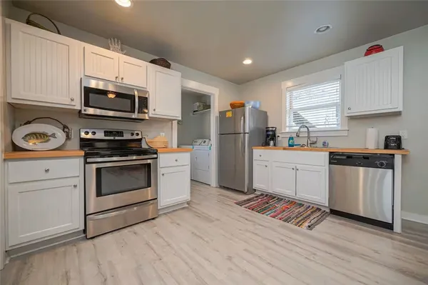 a kitchen with stainless steel appliances a refrigerator stove and microwave