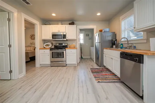 a kitchen with stainless steel appliances a refrigerator and a stove top oven