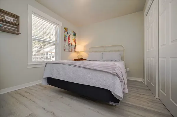 a bedroom with a bed lamp and a window