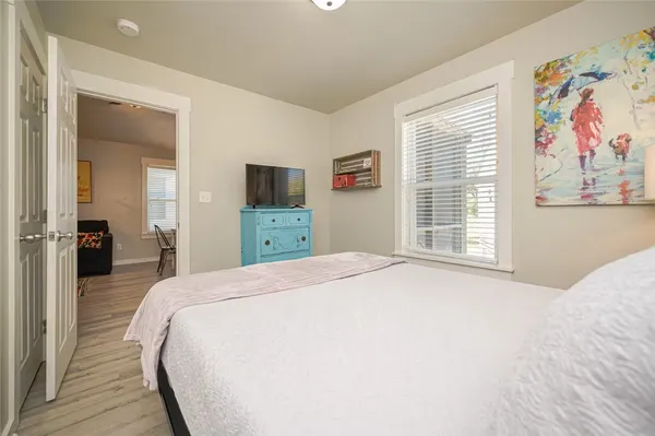 a bedroom with a large bed and a window