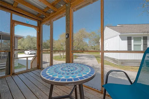 a view of a balcony with a dining table and chairs