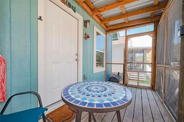 a view of a balcony with a table and chair