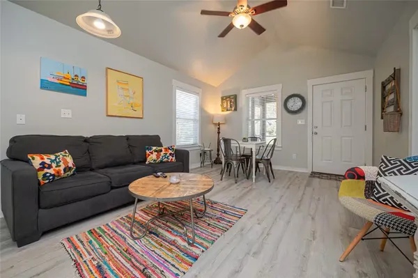 a living room with furniture and a wooden floor