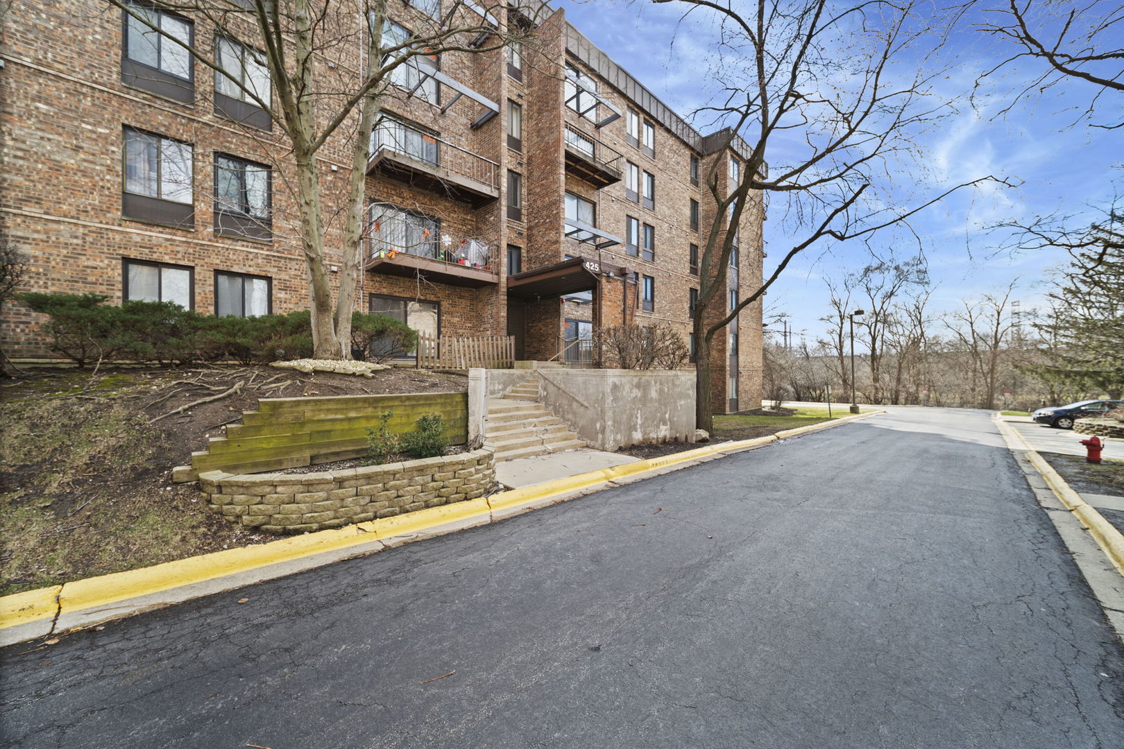 425 Walnut Creek Road, Unit 1401 Lisle, IL 60532 - Photo 1 of 19 a view of a house with snow on the road