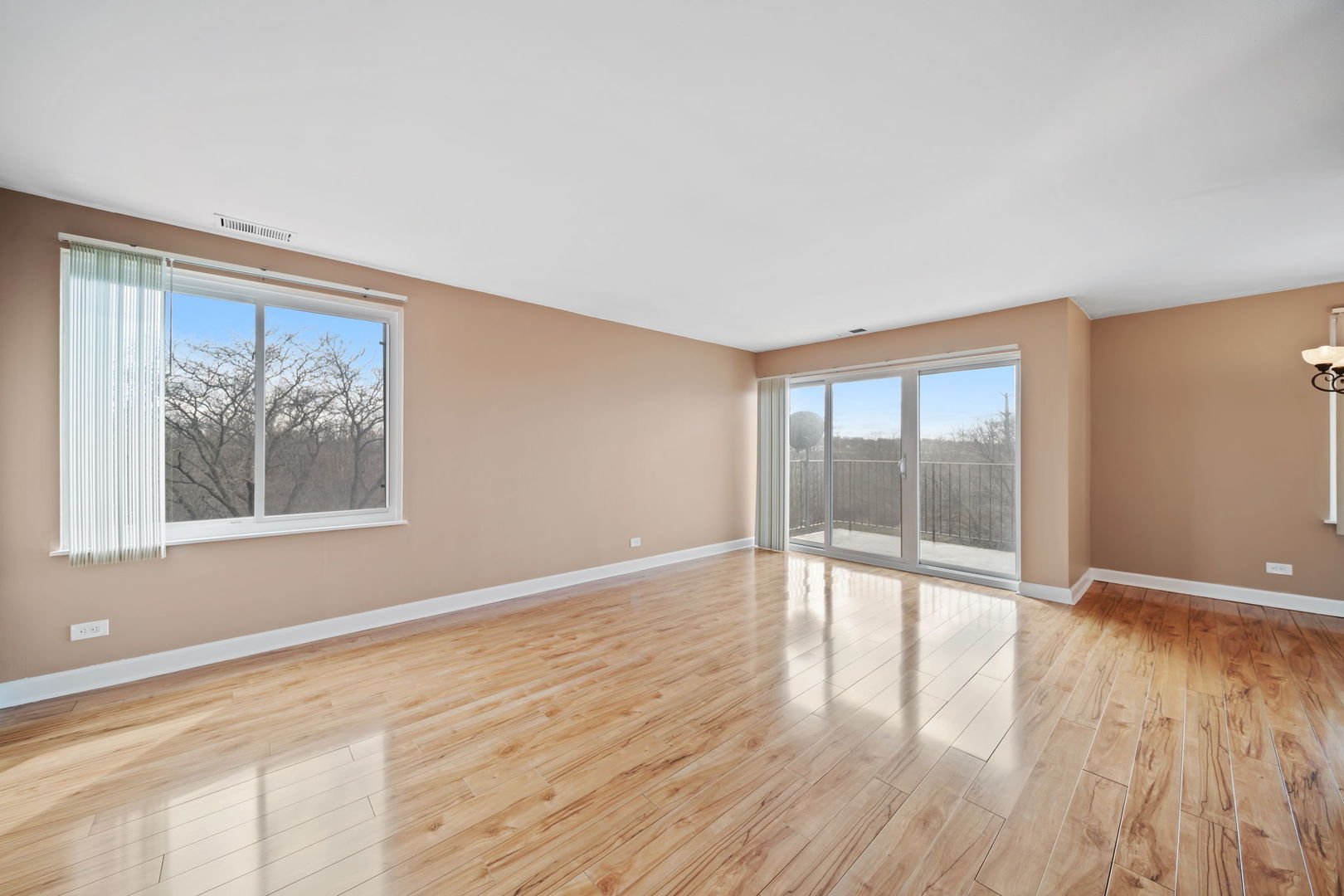 425 Walnut Creek Road, Unit 1401 Lisle, IL 60532 - Photo 2 of 19 a view of an empty room with wooden floor and a window