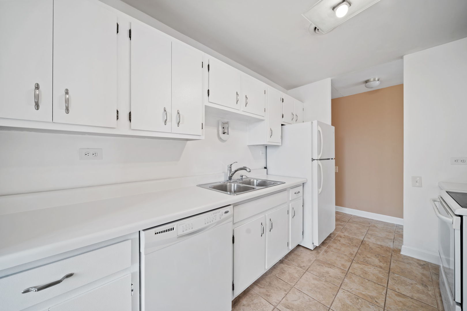 425 Walnut Creek Road, Unit 1401 Lisle, IL 60532 - Photo 7 of 19 a kitchen with stainless steel appliances granite countertop a sink and a refrigerator