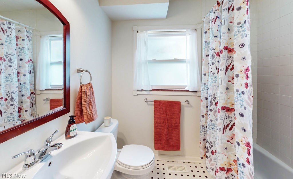 1200 Winston Road Cleveland, OH 44121 - Photo 17 of 35 Updated first floor full bathroom with tiled floor and tub/shower combo