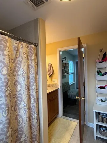 a bathroom with a shower and a sink
