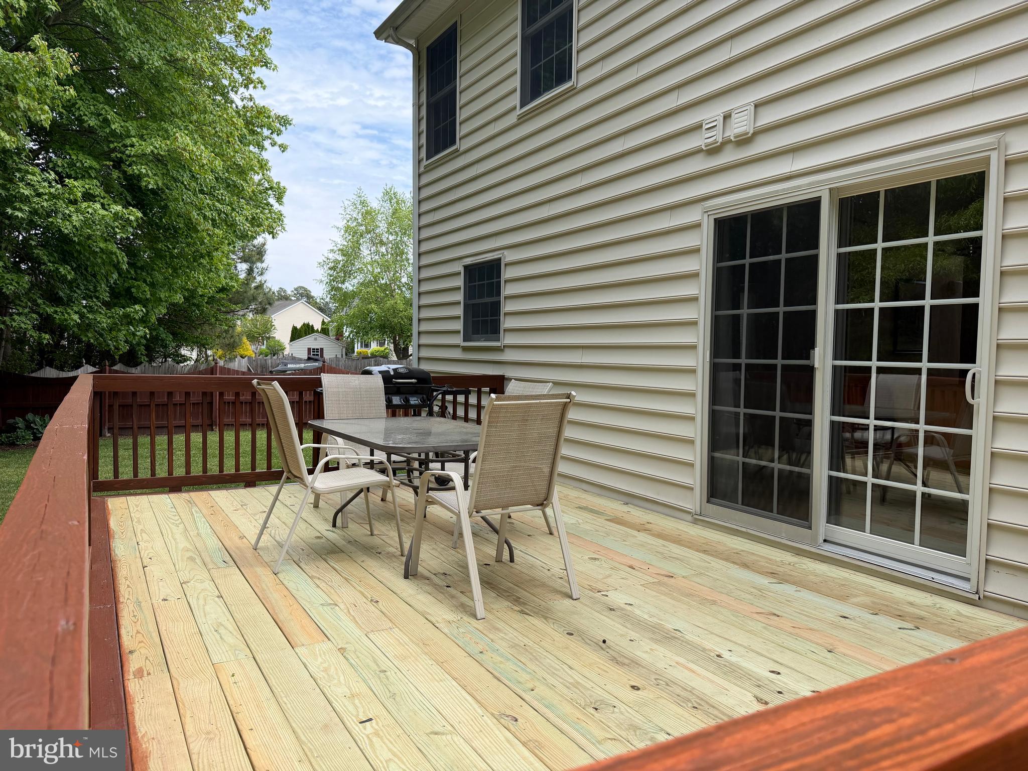112 Rilian Court Grasonville, MD 21638 - Photo 37 of 55 a view of a patio with table and chairs with wooden floor and fence