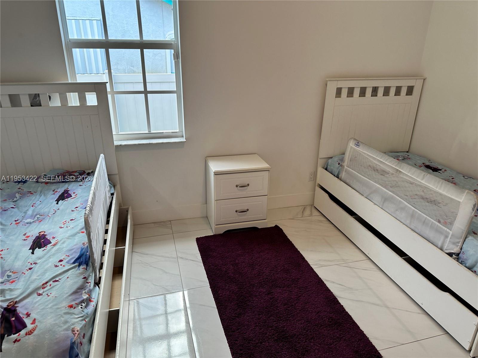 1222 Southwest Herald Road Port St. Lucie, FL 34953 - Photo 14 of 25 a bedroom with a bed and wooden floor